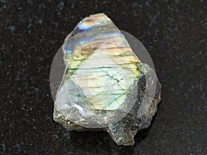 polished surface of labradorite stone on dark