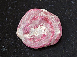 polished Thulite gemstone on dark background