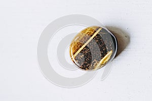 Polished tiger eye tumbled stone pebble on a white background with empty space