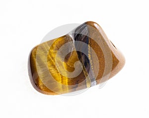 polished tiger's eye (tiger-eye) gemstone on white