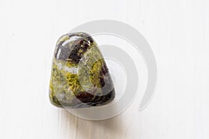 Polished tumbled stone heliotrope jasper or dragon`s blood stone on a white background