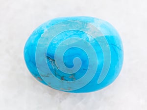polished Turquenite (blue howlite) stone on white photo