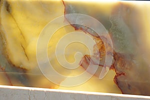 Polished yellow natural stone, backlit, called onyx