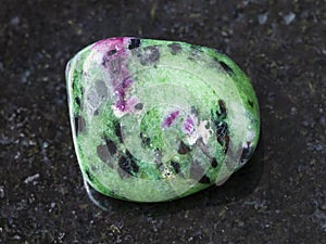 polished zoisite (anyolite) gemstone on dark