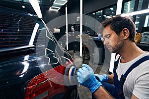 Polishing of auto taillight in repair workshop