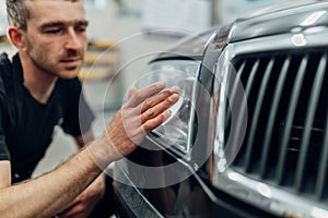 Polishing of car headlight on carwash service