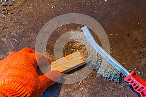 Polishing a wooden block with a metal brush