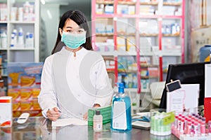 Polite chinese druggist in protective facial mask