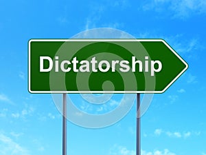 Political concept: Dictatorship on road sign background