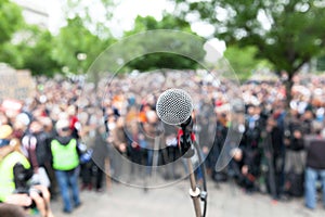 Political protest. Demonstration. Microphone in focus against bl