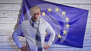 Politician loser. Young palatik crying against the background of the European flag. Funny politician screwed up.