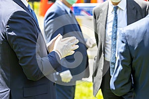 Politicians or businessmen talking at meeting wearing protective gloves and masks during coronavirus COVID-19 pandemic