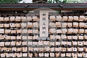 Poll hanging alot of ema traditional wooden prayer board. photo