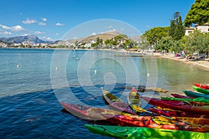 View of the bay of PollenÃ§a (Spain) with some colored kayaks in the foreground