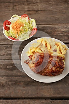 Peruvian food called Pollo a la brasa with salad and french fries photo