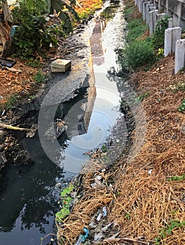 Polluted canal and dirty sewer in an urban area