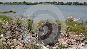 Polluted river bank-dunghill by the water