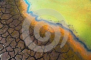 Polluted water and cracked soil during drought