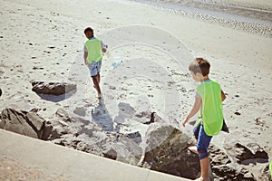 Pollution, cleaning and children with dirt on beach for clean up, environment care and eco friendly volunteer