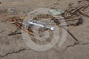 Pollution environment with garbage and bottle on sand beach