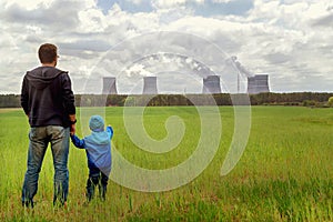 Pollution. Environmental problem. Father and son looking on a emissions of plant.