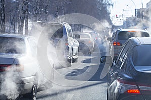 Pollution from the exhaust of cars in the city in the winter. Smoke