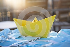 Pollution from masks with a paper boat concept art. Sea of masks