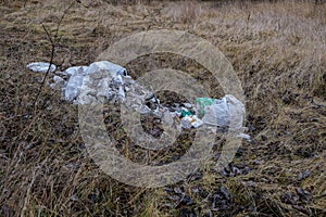 Pollution of the planet. The plastic bottle contaminates the soil.