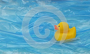 Pollution Plastic In Sea with Yellow Rubber Duck Toy and Plastic Waves
