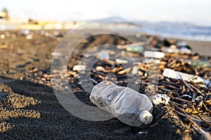 Pollution - plastic water bottle on a beach