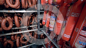 Polony sausage sticks and krakow sausages are shown in a storage facility