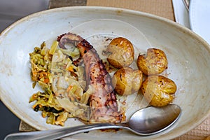 polvo a lagareiro grilled octopus popular food in portugal Porto on a dish in a restaurant photo