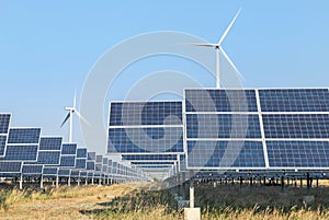 Polycrystalline silicon solar panels and wind turbines generating electricity in hybrid power plant