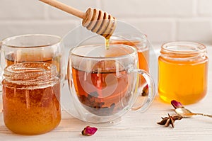 Polyfloral honey flows from a wooden honey spoon