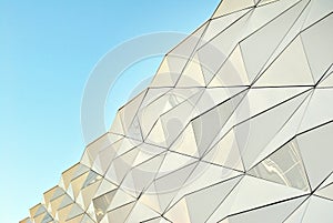 Polygonal triangle glass facade of modern building.