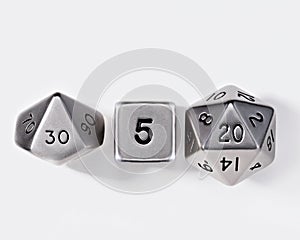 polyhedral dice set made from silver metal with black details