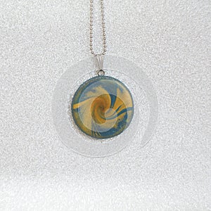 Polymer clay necklace pendant blue and gold swirl