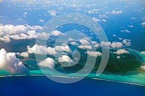 Polynesia. The atoll in ocean through clouds.Sea tropical landscape in a sunny day