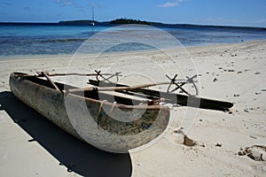 Polynesian canoe on beach photo