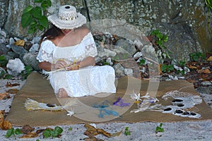 Polynesian Cook Islander woman weaving a hand fan in Rarotonga C