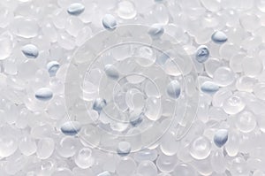 Polypropylene granule with a polymer additive close-up, background texture