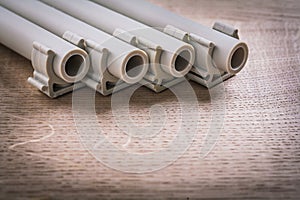 Polypropylene Pipe With Clips On Wooden Board