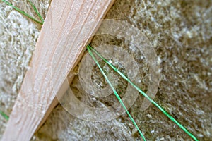 Polypropylene thread supports mineral wool between rafters, close-up