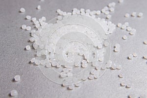 Polypropylene transparent granules on the grey background