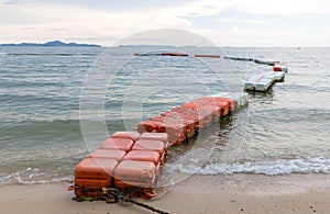 Polystyrene buoy on the sea surface. floating buoys and rope dividing area on the beach.