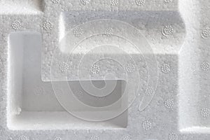 Polystyrene or styrofoam padding for product packaging. Detail of styrene foam plastic box close-up