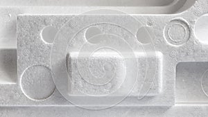 Polystyrene or styrofoam padding for product packaging. Detail of styrene foam plastic box close-up