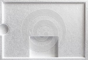 Polystyrene or styrofoam padding for product packaging. Detail of styrene foam plastic box close-up photo