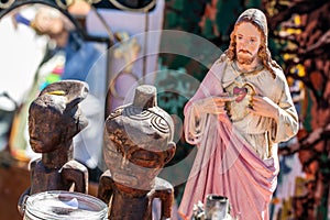 Polytheism religion symbols, Christ and wooden African statues at garage sale