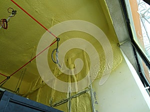 Polyurethane insulating foam that has been sprayed and covered the concrete slabs and walls surface.